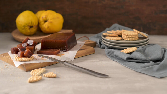 Marmelada de marmelo with crackers on a wooden board