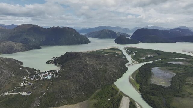 Aerial perspective of the unique village of Caleta Tortel with wooden walkways and houses built along the lush. Patagonia, Chile.