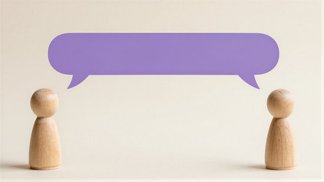 Two wooden figures face each other with a purple speech bubble above.