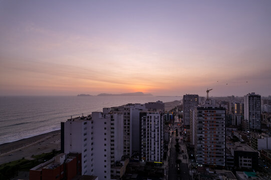 Aerial view of the coastal skyline of Magdalena del Mar at sunset with high-rise apartment buildings overlooking the Pacific Ocean in Magdalena del Mar, Lima Province, Peru.