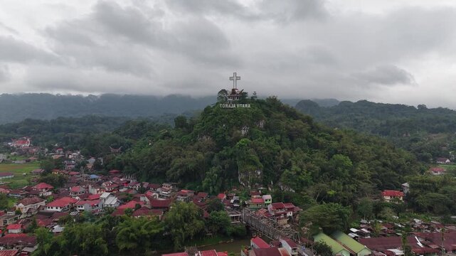 mountain landscape with Toraja Utara landmark statue