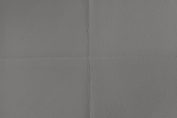 Fototapeta premium Textured gray paper background with subtle folds