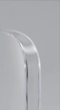 Minimalist glass corner macro acrylic edge smooth transparent surface soft grey background modern clean abstract design glossy curve close up texture rounded rectangle subtle reflection minimal