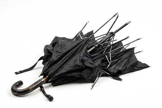 Broken, folded umbrella with bent metal spokes after a storm