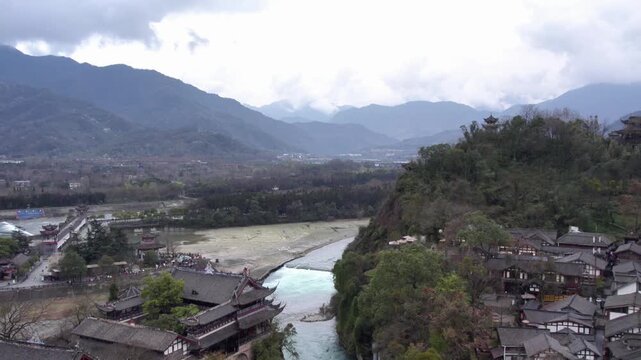 A historic ancient water conservancy site nestles between mountains and rivers, with traditional architecture and natural landscape.