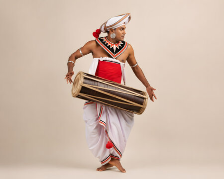 Sri Lankan Traditional Geta Beraya (Kandyan Drum) Musician in a Minimal Backdrop