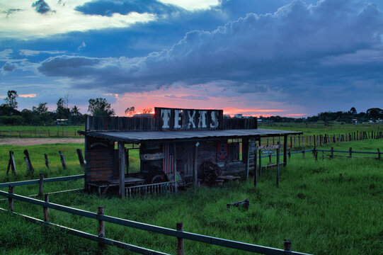 Rustic western cowboy style wooden ranch with Texas sign at sunset in Thailand.