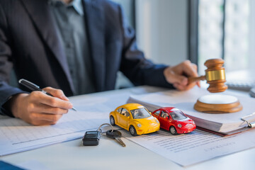 Fototapeta premium Lawyer writing on document and knocking gavel car insurance concept