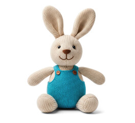 Fototapeta premium A beige knitted rabbit sits on a transparent background. The rabbit has long ears, a smiling face with button eyes and a blue denim overall.