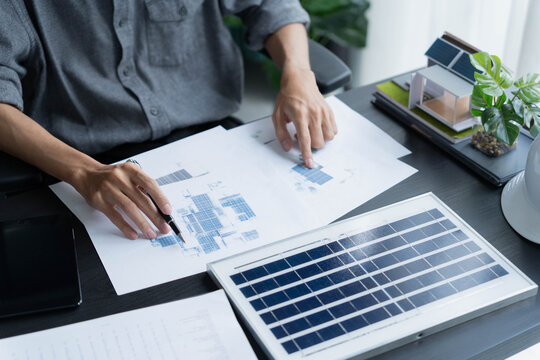 Electrical engineer working on solar panel blueprint sustainable energy