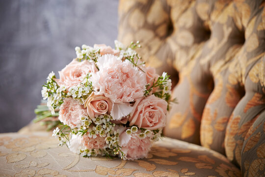 A bouquet of flowers on a vintage chair