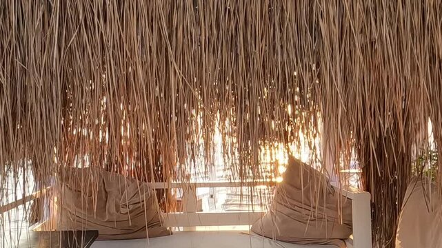 Luxury Beach Cabana Interior with Thatched Roof at Sunset Resort Lounge