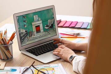 Obraz premium Person designing interior room on laptop with color swatches