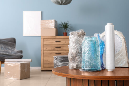 Packed household items wrapped in plastic for moving
