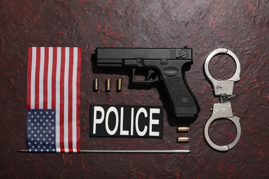 Police equipment with handgun, handcuffs, and American flag