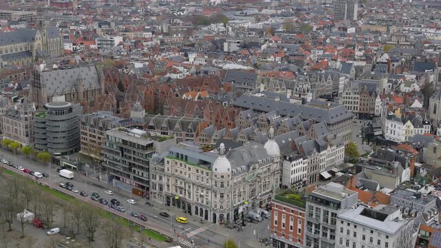 Cinematic drone reveal beginning near a city building and expanding into a panoramic view of Antwerp, showcasing MAS, The Steen, and the Scheldt waterfront.