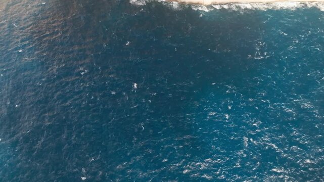 Revealing of Dingli Cliffs in Malta with a drone. coastal cliffs meeting the ocean during the day.