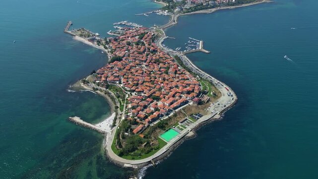 Slow right rotation of a drone reveals historic Nessebar on a peninsula surrounded by the waters of the Black Sea in Bulgaria.