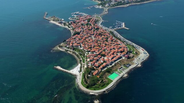 Slow left rotation of a drone reveals historic Nessebar on a peninsula surrounded by the waters of the Black Sea in Bulgaria.