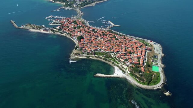 Drone slowly rotates left above historic Nessebar, revealing the peninsula surrounded by the waters of the Black Sea in Bulgaria.