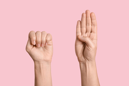 Hands showing American Sign Language letters S and W