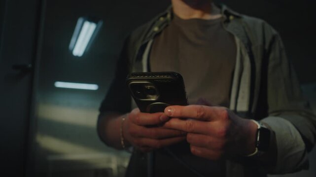 Close Up of Athletes Hands Using Mobile Phone and Wearing White Smartwatch. Modern Connectivity and Data Tracking During Fitness Routine in Sports Club. Concept of Modern Technology For Health.