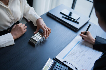 Fototapeta premium Two Asian businesswoman trading silver bar together in office. silver trading concept
