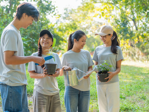 Group of volunteers planting trees together in outdoor environmental activity