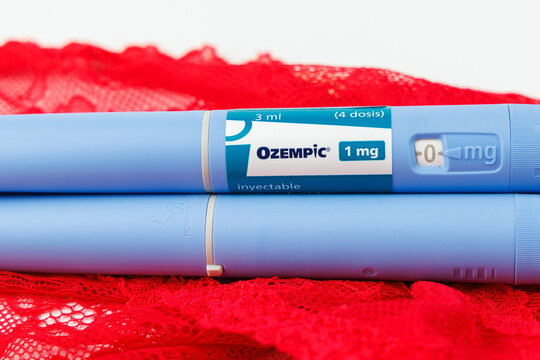 Blue ozempic medication pen pack on red lace underwear over white background for morbid obesity and metabolic health treatment. In Barcelona -Spain; June 25, 2026.