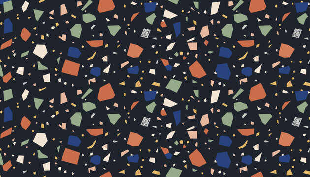 Terrazzo seamless pattern featuring colorful stone chips in blue, green, and orange on a dark navy blue background.