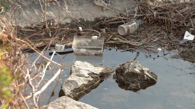 Plastic Waste and Debris Polluting a Riverbank in Kyoto Japan