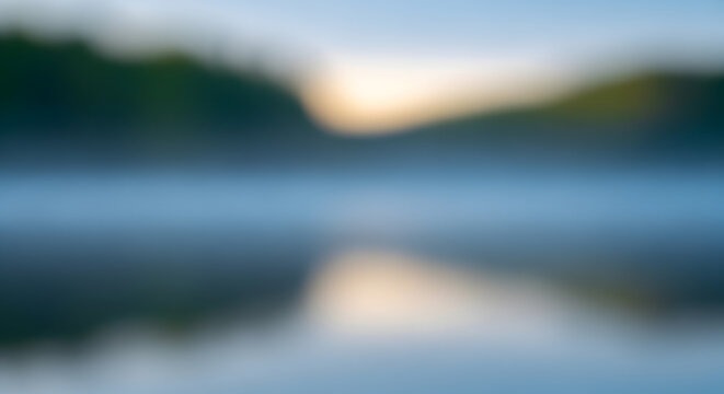 Abstract blurry landscape reflecting on water