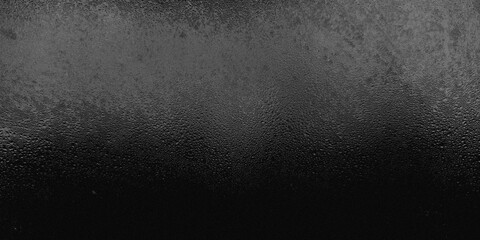 Obraz premium Dark black frosted glass texture with grainy noise and tiny condensed water rain drops. Abstract textured background with subtle top light gradient effect