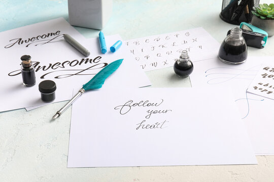 Calligraphy practice with ink and quill pen on white paper