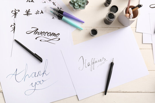 Calligraphy practice with positive words and writing tools
