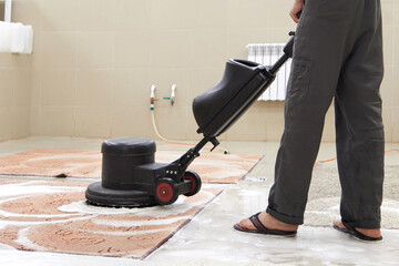 Fototapeta premium Carpet chemical cleaning with professionally disk machine. Early spring cleaning or regular clean up.