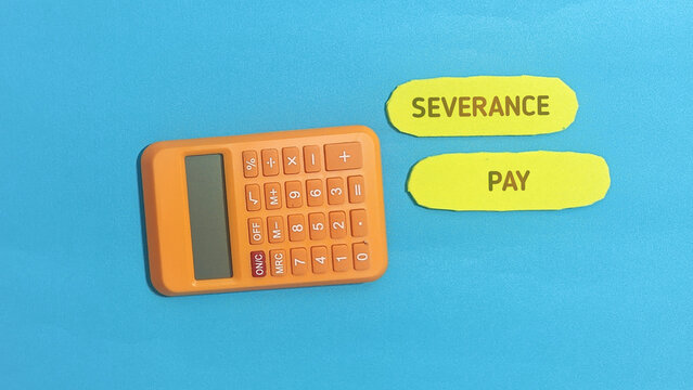 Bright orange calculator placed beside yellow paper labels featuring the text severance pay on a solid blue surface captured from a high angle top view