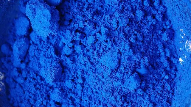 Bright blue powder in close up view on a flat surface