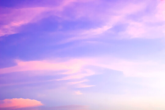 Beautiful pastel purple and pink sunset sky background with soft clouds