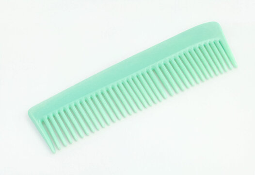 Mint green plastic hair comb isolated on white background