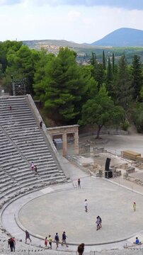 Woman walking down the stairs of ancient theater of Epidaurus