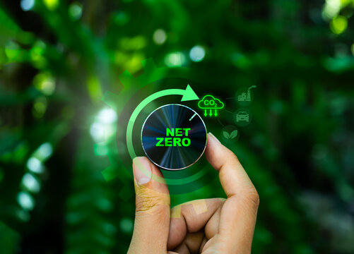 Net zero industrial transformation concept. Hand turning knob with sustainability icons. ESG implementation, carbon management systems, decarbonization processes, and green manufacturing strategies.