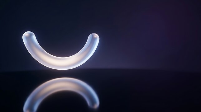 Glowing white dental retainer or mouth guard on dark reflective surface with soft illumination