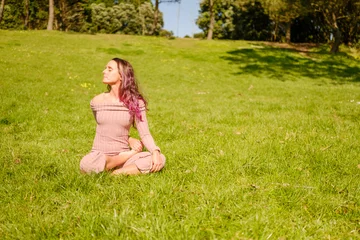 Fotobehang Lotusbloem Woman meditating outdoor in lotus yoga pose  © Digito  Pitoresco