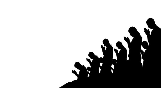 A silhouette of a group of people praying together in unity.