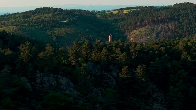 Aerial shot revealing Grangent Castle in the middle of the Gorges de la Loire at sunset on a beautiful day, Loire departement, Auvergne RHone Alpes region, FRrnce