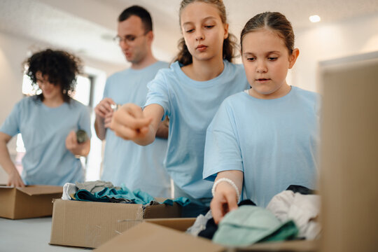Volunteers sorting donated clothes for charity and community service