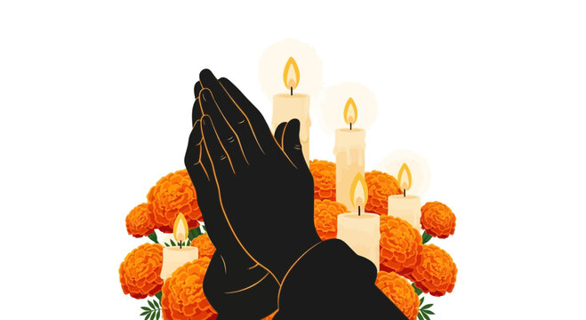A pair of hands pressed together in prayer surrounded by marigold flowers and lit candles.