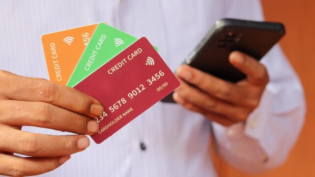 A person holds multiple credit cards illustrating the ease of online shopping and financial management.