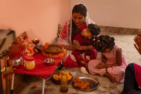 Family praying together during a religious ceremony.